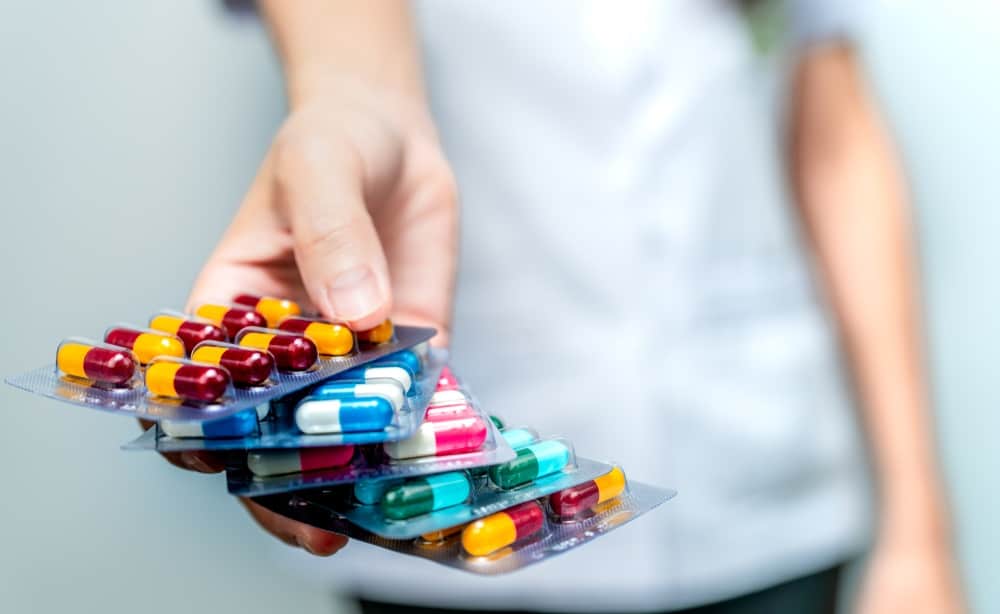 hand holding pack of antibiotic capsule pills